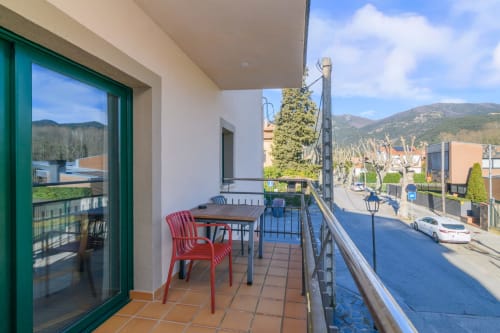 Spacious balcony at Rural Montseny apartment in Gualba with mountain views, terrace seating, and Montseny mountains in