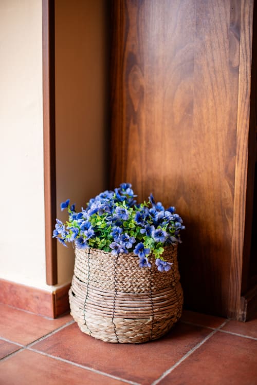 Blue flowers in woven basket at Finca Navalpino entrance, Guadamur