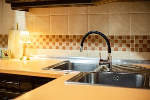 Modern kitchen sink with black faucet at Finca Navalpino B&B in Guadamur, Spain
