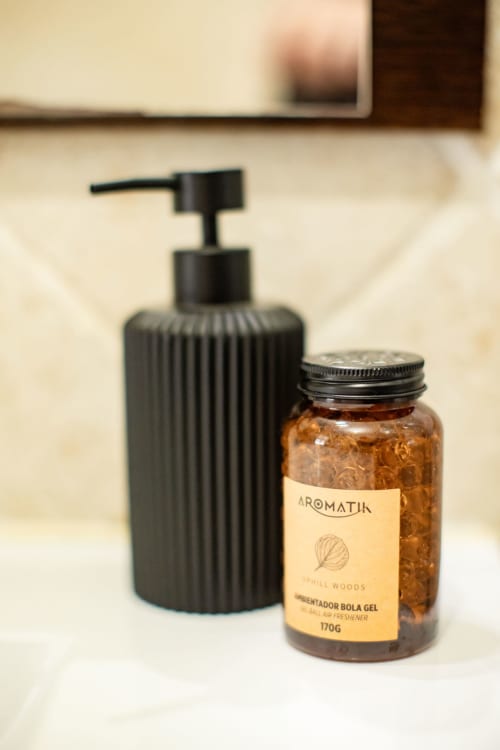 Aromatin gel air freshener and black soap dispenser on bathroom counter at Finca Navalpino