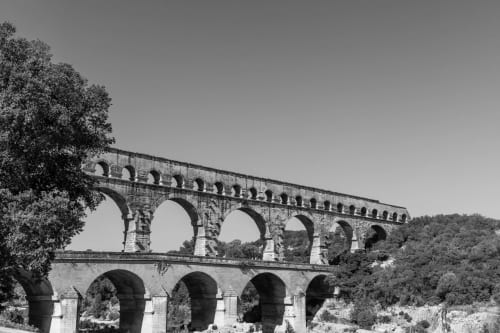 Historic Roman aqueduct bridge near Le Prieuré Notre-Dame B&B in Montfrin, France, showcasing ancient stone architecture