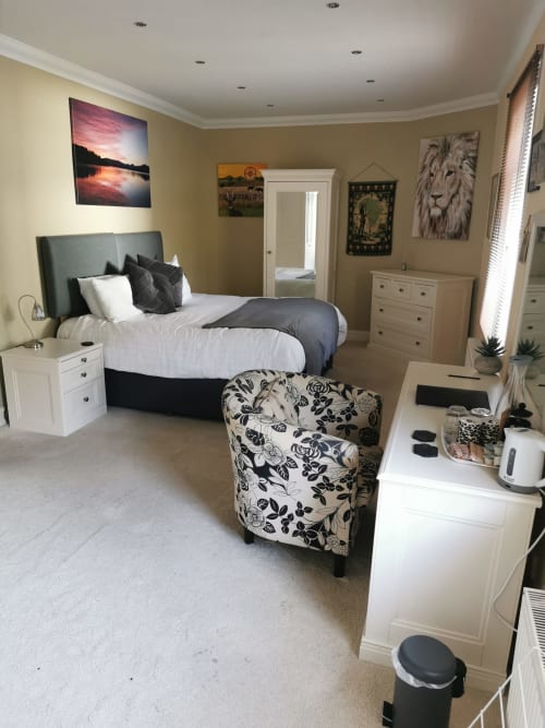 Large double bedroom at Arrochoile Glasgow B&B with bed, white furniture, and classic decor