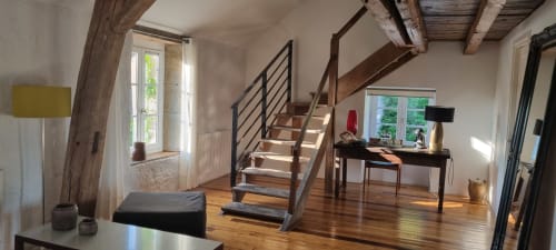 Moulin Renaudiots Arroux room with wooden stairs, desk, garden views, and exposed beams in Autun