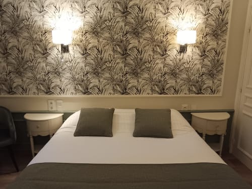 Comfortable double bedroom at Le Pavillon Saint Martin Hotel, Souillac with palm wallpaper and modern amenities
