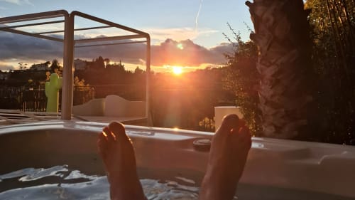 Guest's feet relaxing in hot tub at sunset, Villa Colina B&B in Mandelieu la Napoule with panoramic views