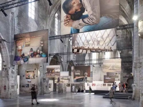 Modern gallery space at Le Prieuré Notre-Dame displaying intimate family moments and architectural photographs in Montfrin
