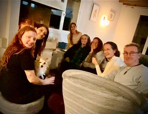 Group gathering at La Cachette d'Oona B&B in Saint-Jean-de-Monts with small white dog