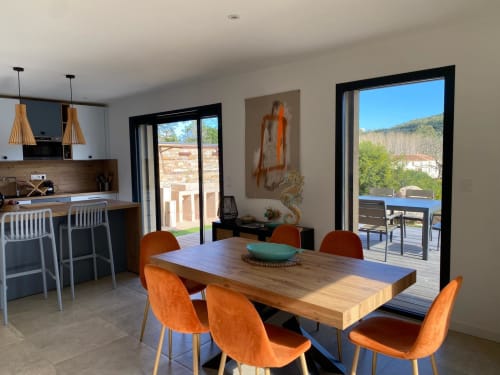 Modern dining area with orange chairs, wooden table, and panoramic views of Favone in Villa Ô Bord de Mer , managed by Corsu Di Core