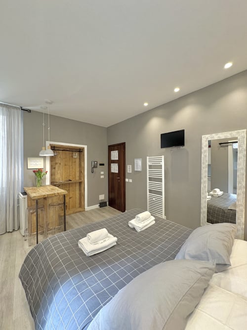 Camera moderna dell'Hotel Le Arche a Verona con letti matrimoniali, angolo cottura e bagno privato