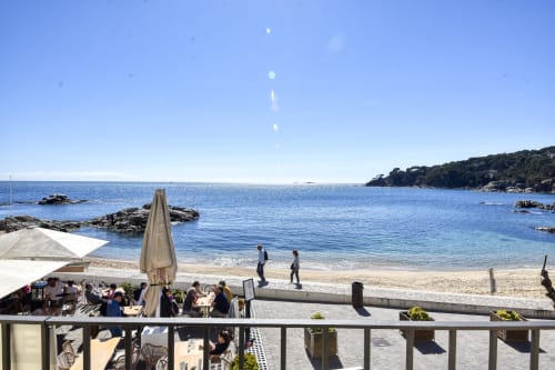 Beachfront terrace at Palafrugell apartment with sea view, sandy beach, and Mediterranean coastline