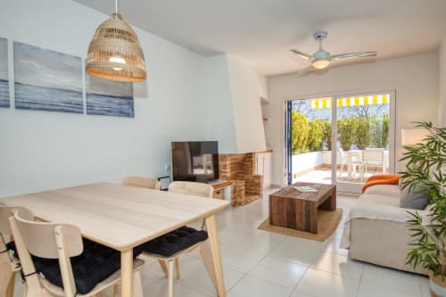 Modern beachfront apartment in Palafrugell with dining area, living room, and terrace access to Canadell beach