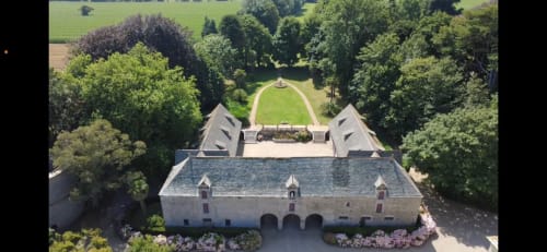 Aerial view of Château d'Alexis de Tocqueville manor with formal gardens, tree-lined grounds in Tocqueville, France