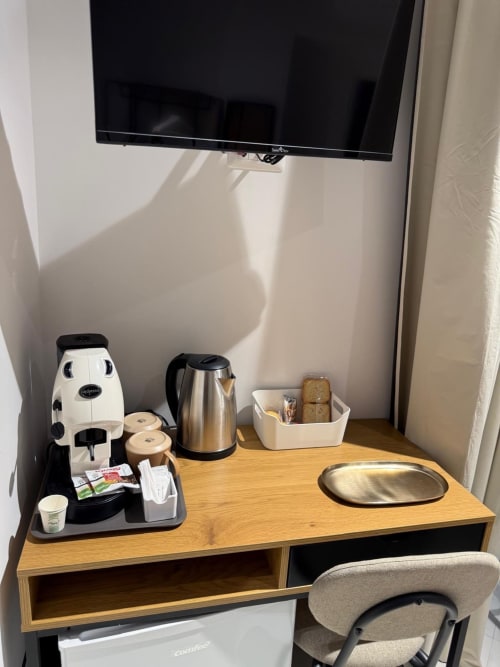 Scrivania della camera d'albergo con macchina caffè, bollitore e servizi presso Tresette Porta Capuana, Napoli