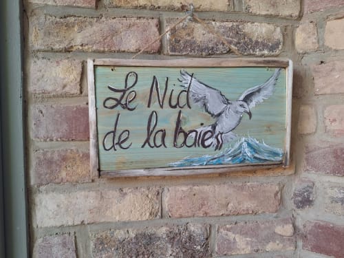Panneau en bois « Le Nid de la baie » orné d'une illustration d'oiseau à La Cour d'Hortense, gîte à Sailly-Flibeaucourt, France