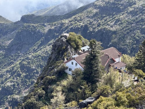 Check Madeira hotel perched on rocky cliff surrounded by forested mountains in Ribeira Brava