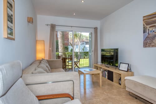 Bright ground floor apartment in Palafrugell with garden view, featuring comfortable seating, TV, and access to shared pool