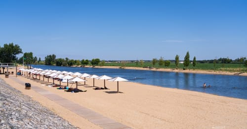 Sandy beach with white umbrellas along the Douro River at Herdade da Cova da Onça, Canha Portugal