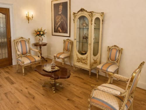 Elegant Venetian sitting room with ornate gold furniture, portrait, display cabinet at Palazzo Titti Venice