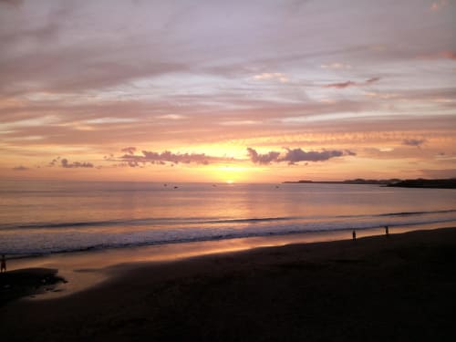 Sunset over the beach at Costa Adeje, Tenerife with golden sky and waves at Marigold Property Services