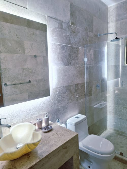 Modern bathroom in Itzamná Suite Deluxe at Playa del Carmen hotel with travertine tiles, vessel sink, glass shower enclosure