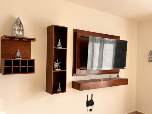 Modern wooden wall-mounted TV entertainment center with shelving in Itzamná Suite Deluxe, Playa del Carmen hotel room