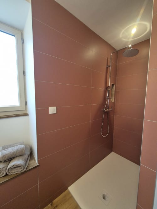 Douche à l'italienne moderne avec carrelage terracotta et pomme de douche pluie à Maisonaurinko, Thénon
