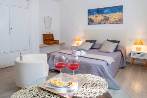 Belvedere del Lago Girasole room with bed, wine glasses, and garden view, Montefiascone