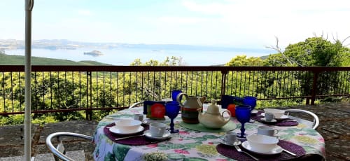 Outdoor dining table set for tea with lake view at Belvedere del Lago, Montefiascone