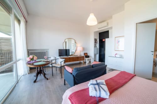 Peonia room at Belvedere del Lago in Montefiascone with lake view, featuring bed, seating area, and balcony