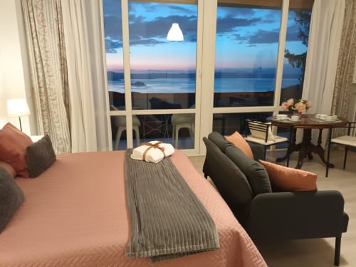 Peonia room at Belvedere del Lago with lake view balcony overlooking Montefiascone at dusk