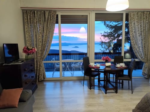 Elegant bedroom at Belvedere del Lago with lake view balcony, dining table, and sunset over water at Montefiascone