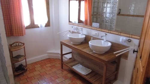 Spacious bathroom with double vanity and wooden countertop at Manoir De La Maison Blanche, Amboise