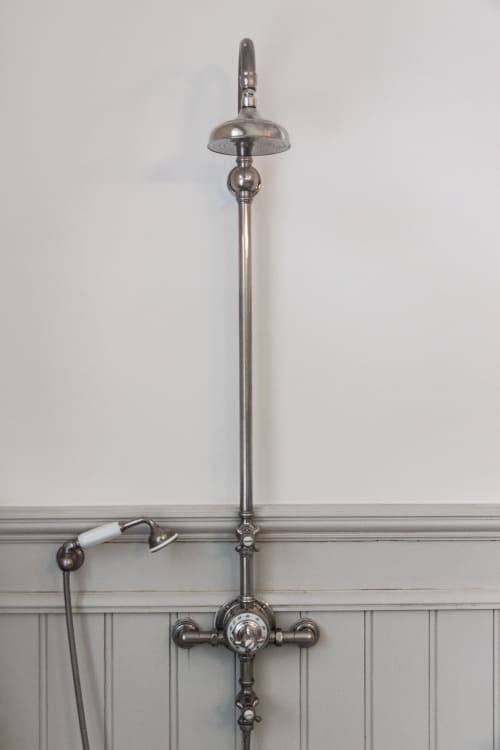 Vintage chrome shower fixture with overhead rainfall showerhead and hand spray in Bernard Suite at Castanea Business &