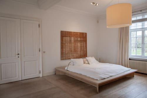 Bernard Suite bedroom at Castanea Business & Suites in Merelbeke with wooden bed, garden view window, and modern amenities