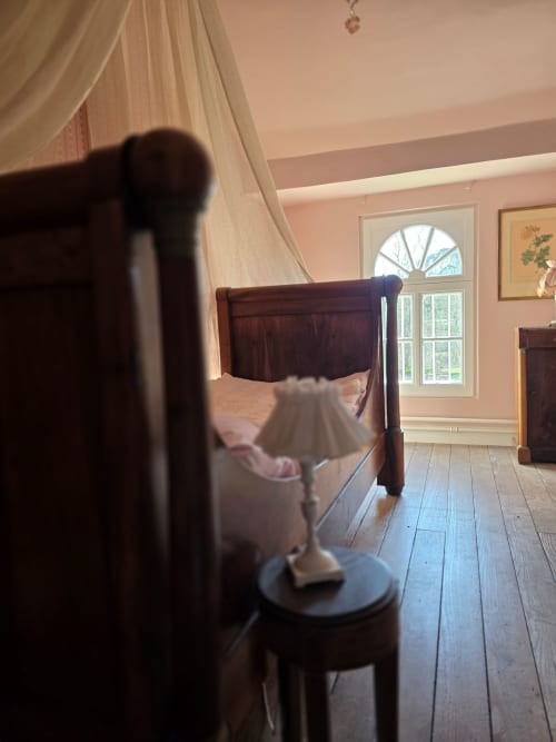 Thérèse Suite bedroom with canopy bed, sheer curtains, and garden view at Castanea Business & Suites, Merelbeke