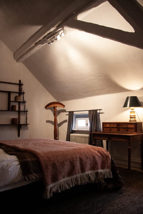 Thérèse Suite at Castanea Business & Suites: attic bedroom with sloped ceilings, wooden furniture, and garden views in