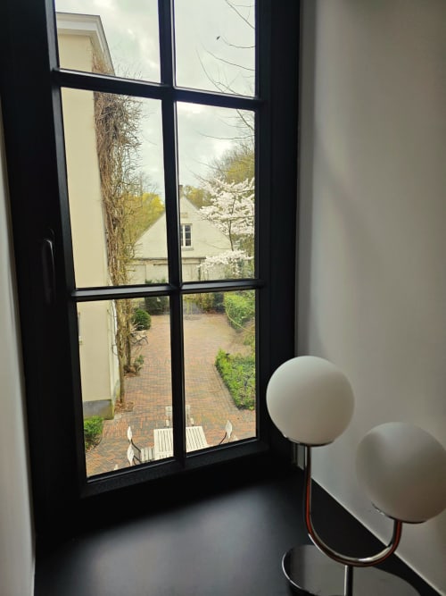 Studio Fabienne apartment at Castanea Business & Suites in Merelbeke overlooks brick courtyard with blooming trees and