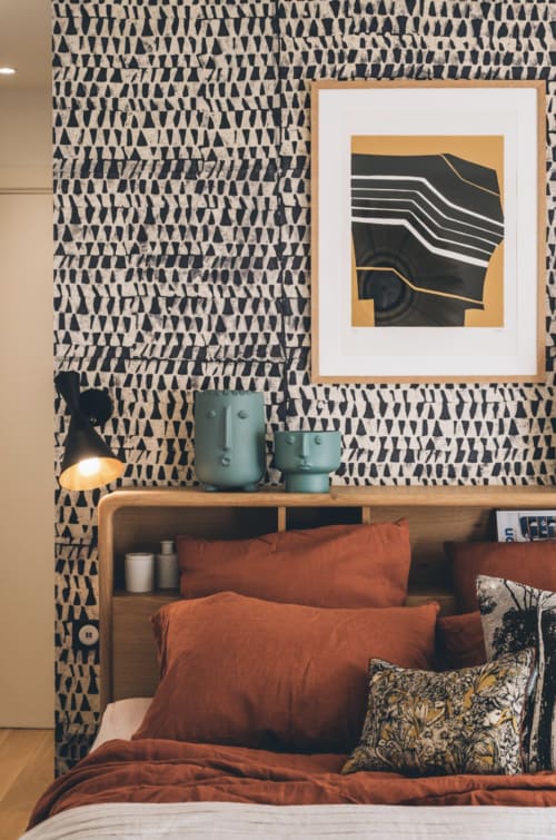 Suite Mont Blanc bedroom at Villa Figue Blanche with patterned wallpaper, wooden bed frame, rust bedding, and abstract