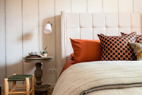 Suite Roche Dorée at Villa Figue Blanche, Montagny-les-buxy. Modern bedroom with cream padded headboard, orange pillows, and