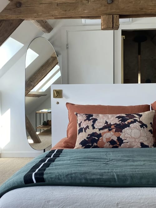 Chambre Ciel Bleu bedroom at Villa Figue Blanche with arched mirror, patterned pillows, and exposed wooden beams