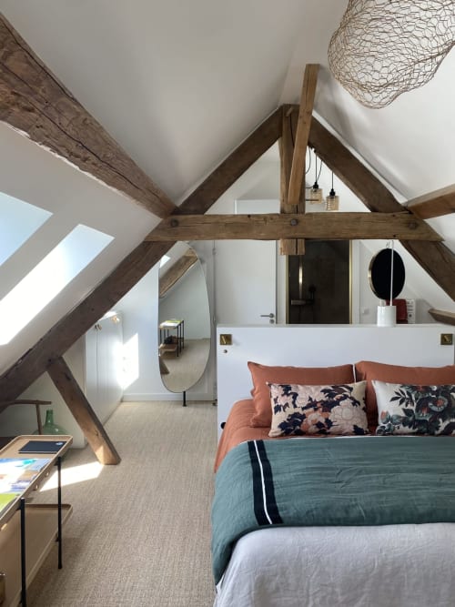 Chambre Ciel Bleu at Villa Figue Blanche: Modern loft bedroom with exposed wooden beams, bed with orange bedding, skylight