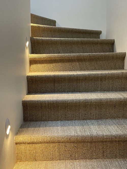 Modern staircase with woven carpet runner and ambient lighting at Villa Figue Blanche B&B in Montagny-les-buxy