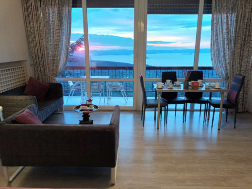Rosa Suite at Belvedere del Lago with panoramic Lake Bolsena views, modern furnishings, and lakeside balcony at sunset