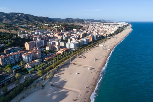 Aerial view of Hotel Continental Calella's beachfront location in Calella, Spain with sandy beach and Mediterranean Sea