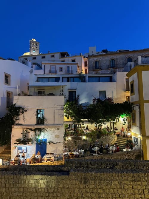 Hotel La Ventana in Ibiza illuminated at dusk with courtyard dining and whitewashed Mediterranean architecture