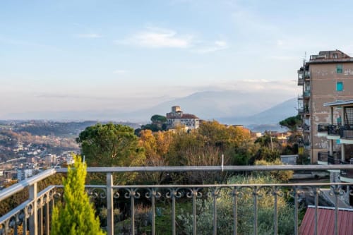 Balcony view of Mount Vesuvius and Ceccano countryside from Torre dei Venti, autumn garden visible
