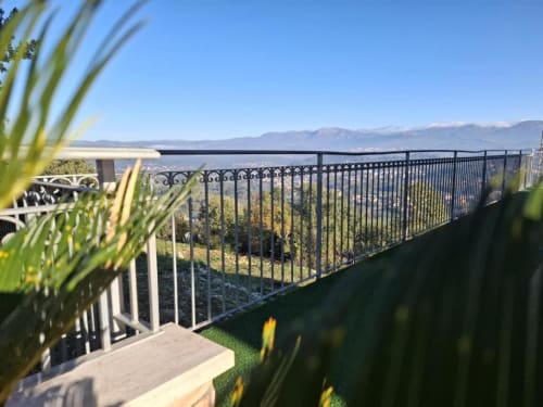 Mistral Room balcony at Torre dei Venti in Ceccano with mountain and city views, ornamental grasses, and railing overlooking