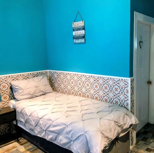 Seashell Suite bedroom at Commodore B&B, Rothesay, with turquoise walls, patterned headboard, and white bedding