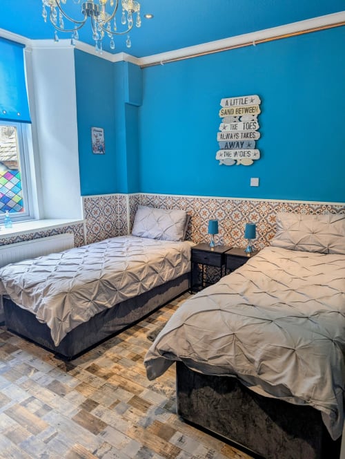 Bright blue bedroom in Seashell Suite at Commodore B&B, Rothesay, with twin beds and coastal decor