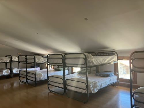 Multiple bunk beds with white bedding in San Donato room at Posada de Ollo hotel, Spain